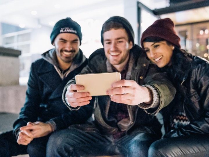 Friends checking a phone together